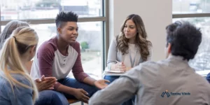 Teen participating in a group therapy session at Turning Winds, supportive environment. Residential treatment programs covered by Cigna Health insurance.